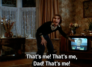 Screencap from Velvet Goldmine. Arthur points at TV and shouts, "That's me! That's me, Dad! That's me!"