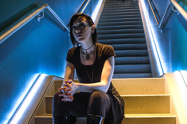 Amber, sitting on stairs, landscape orientation, in colour