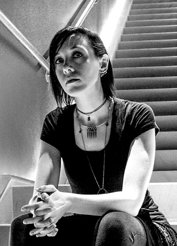 Amber, sitting on stairs, portrait orientation, black and white
